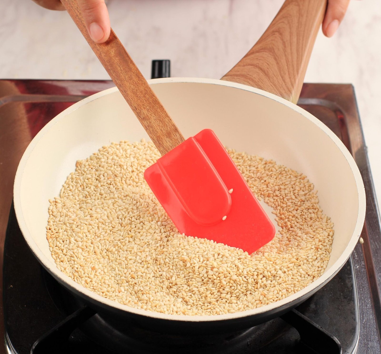 female asian chef roasted sesame seed frying pan